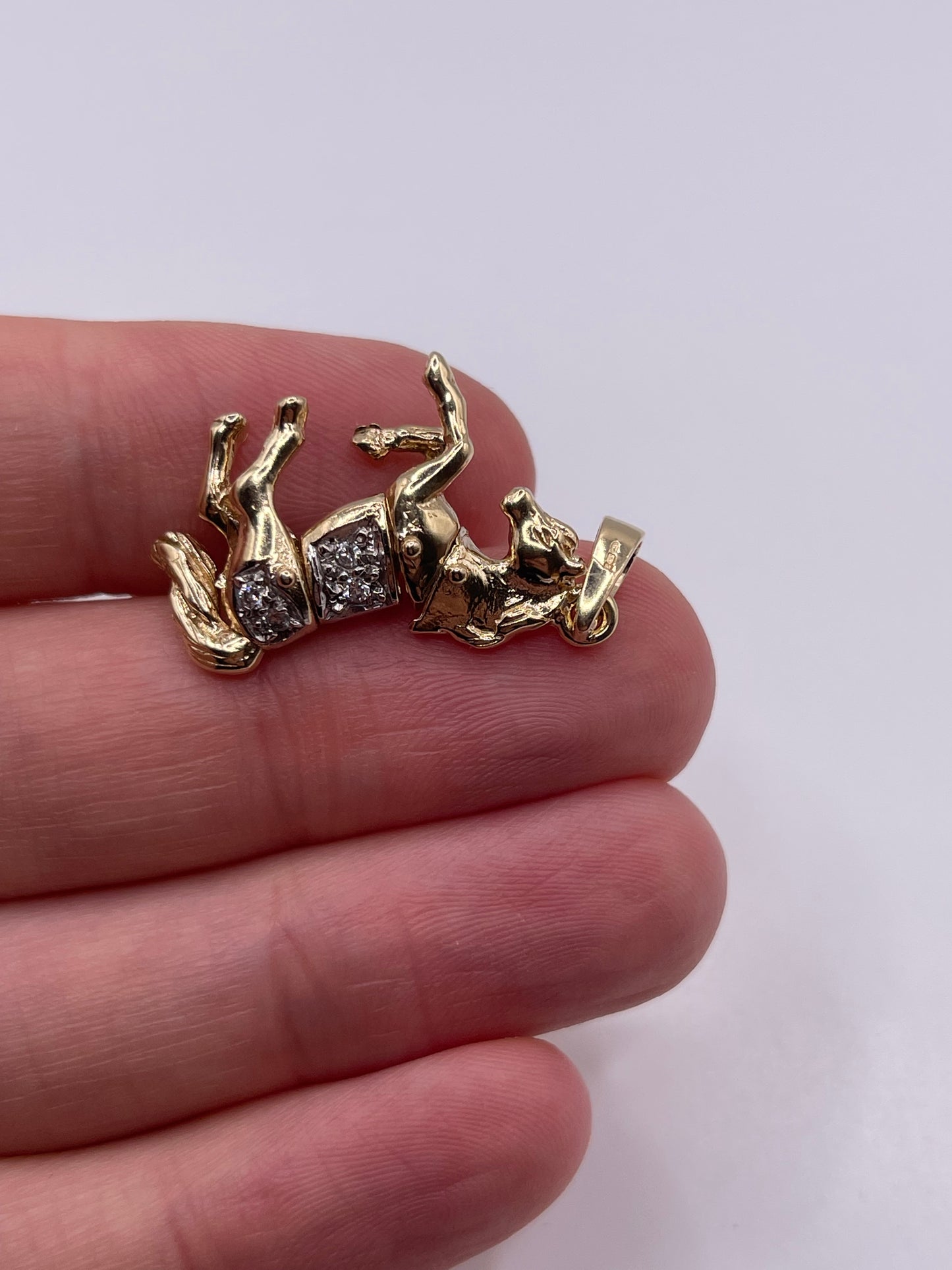 9ct gold stone set articulated horse pendant