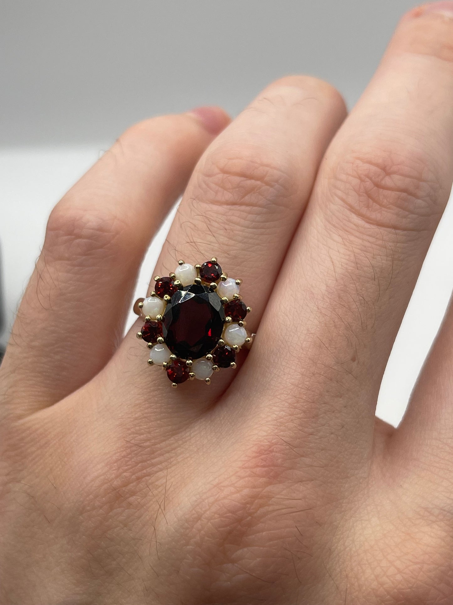 Heavy 9ct gold garnet and opal ring