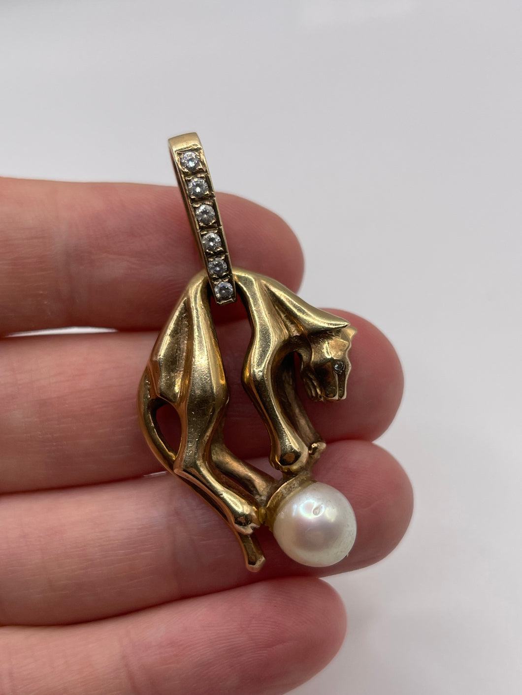 Heavy 9ct gold pearl and cz panther pendant