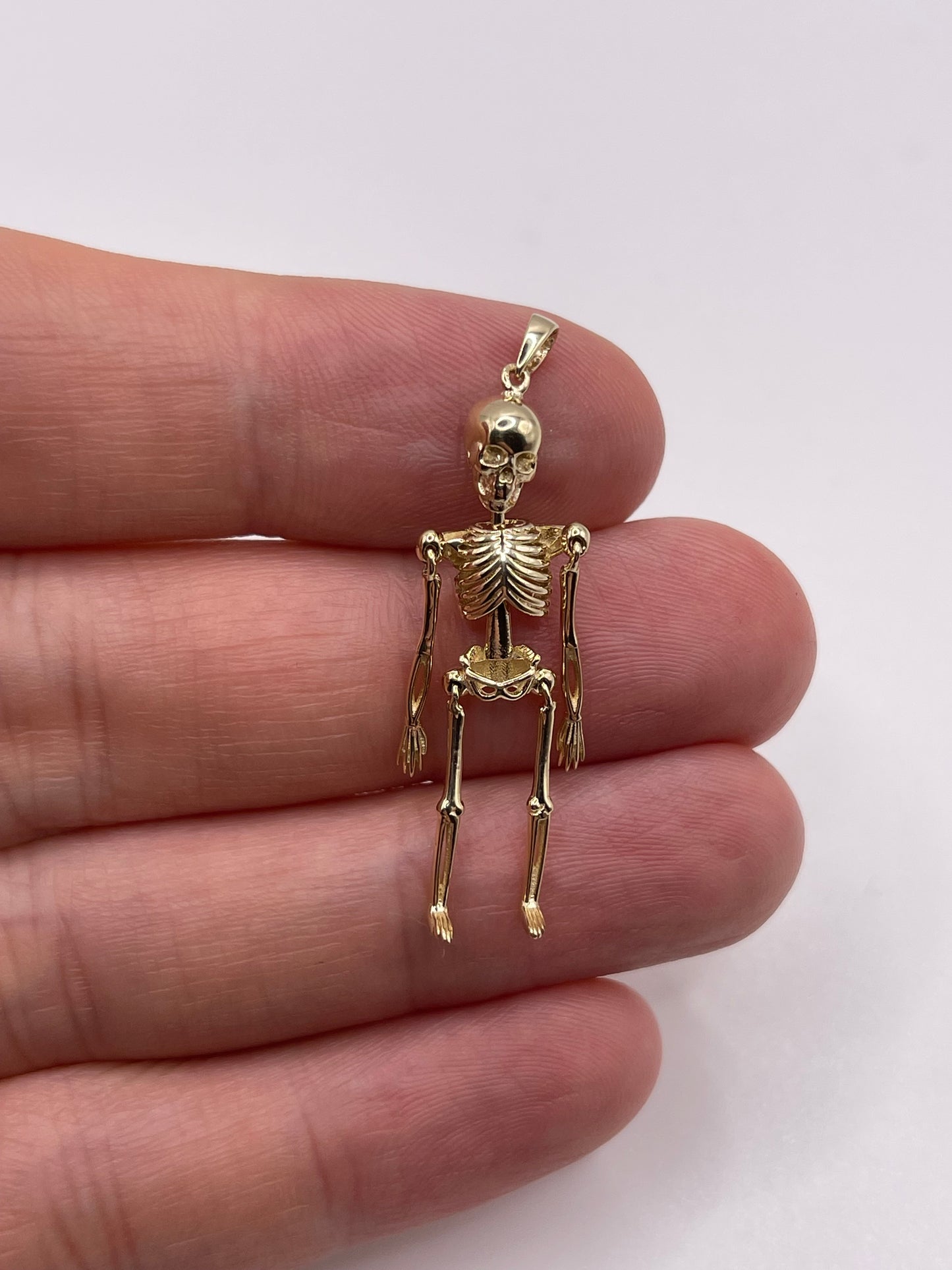 9ct gold articulated skeleton pendant