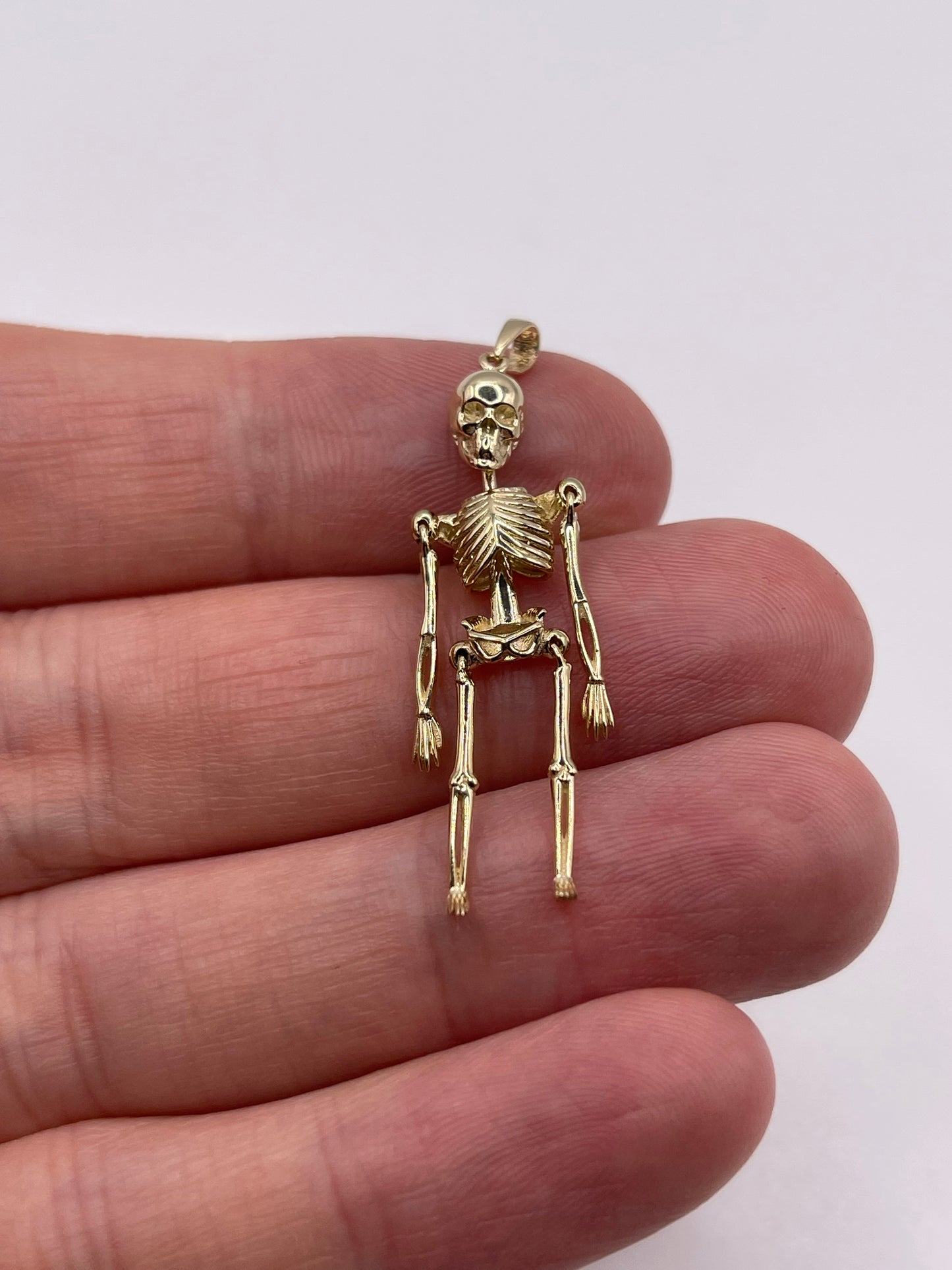 9ct gold articulated skeleton pendant