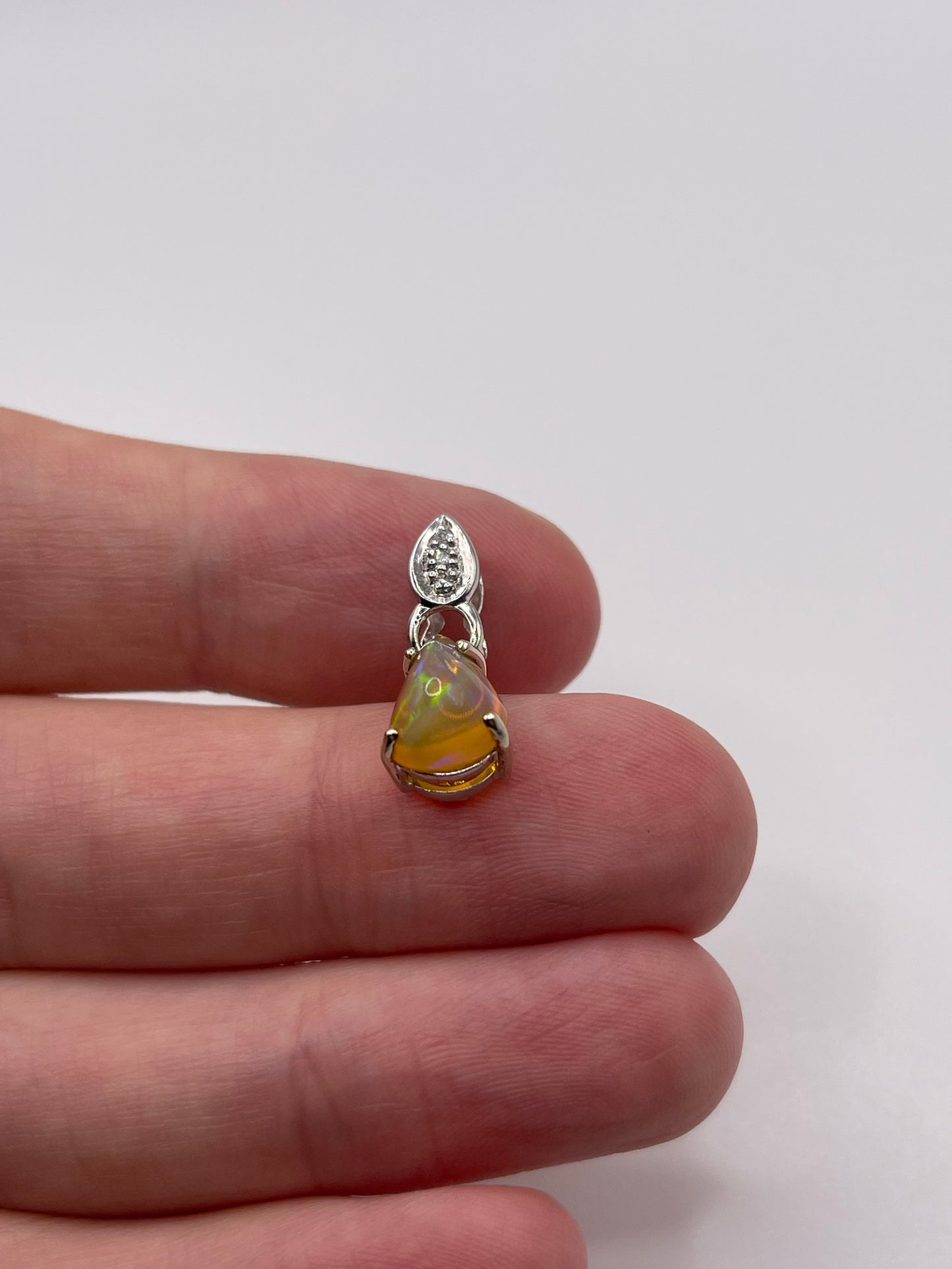 9ct white gold opal and diamond pendant