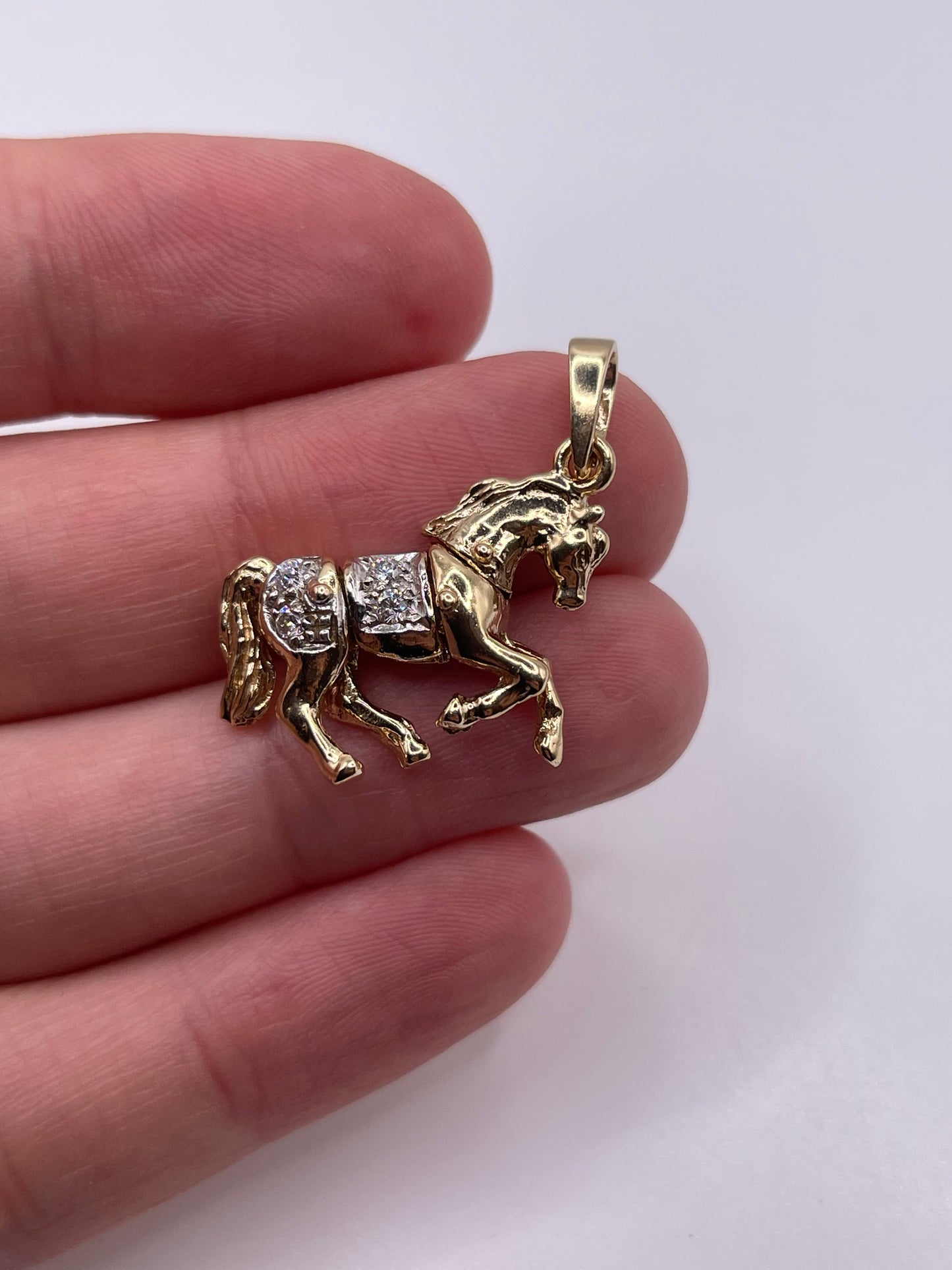 9ct gold stone set articulated horse pendant