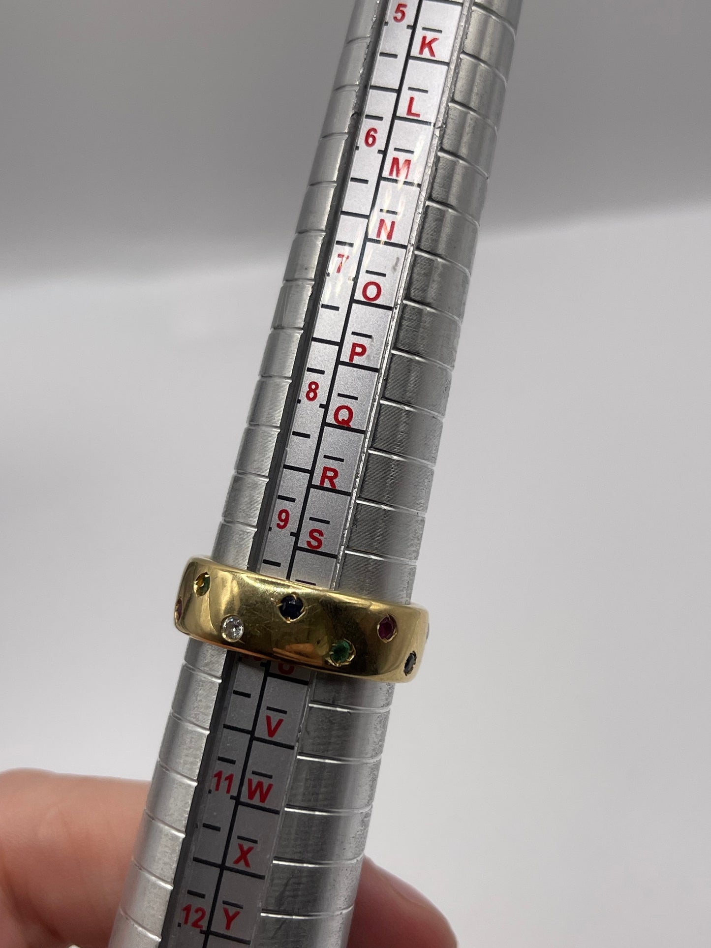 18ct gold ruby, emerald, sapphire and diamond eternity ring
