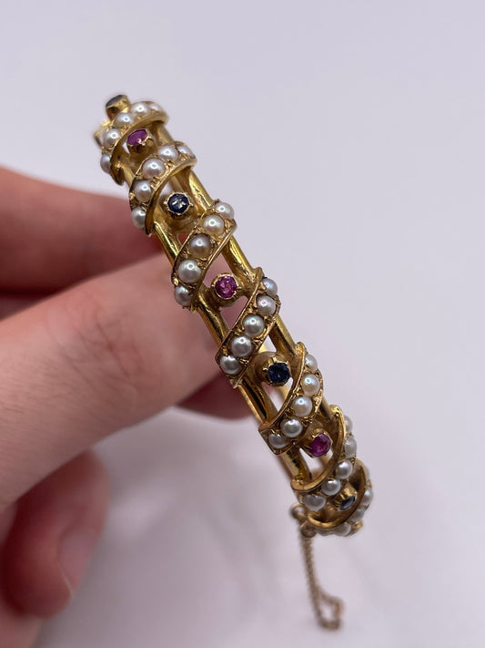 9ct gold ruby, sapphire and pearl bangle