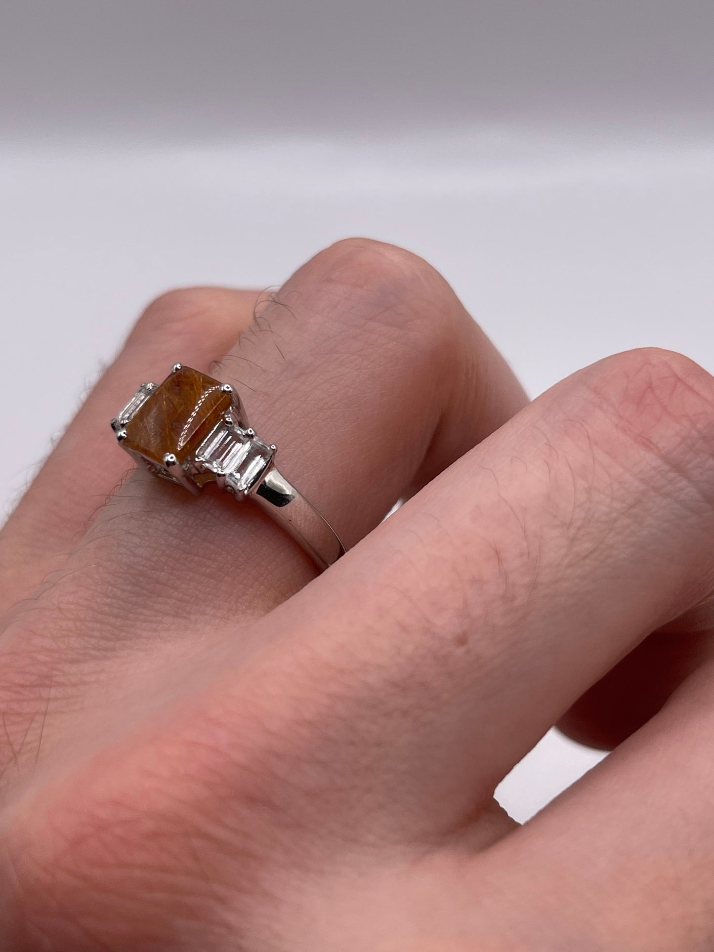 Silver rutile quartz and zircon ring