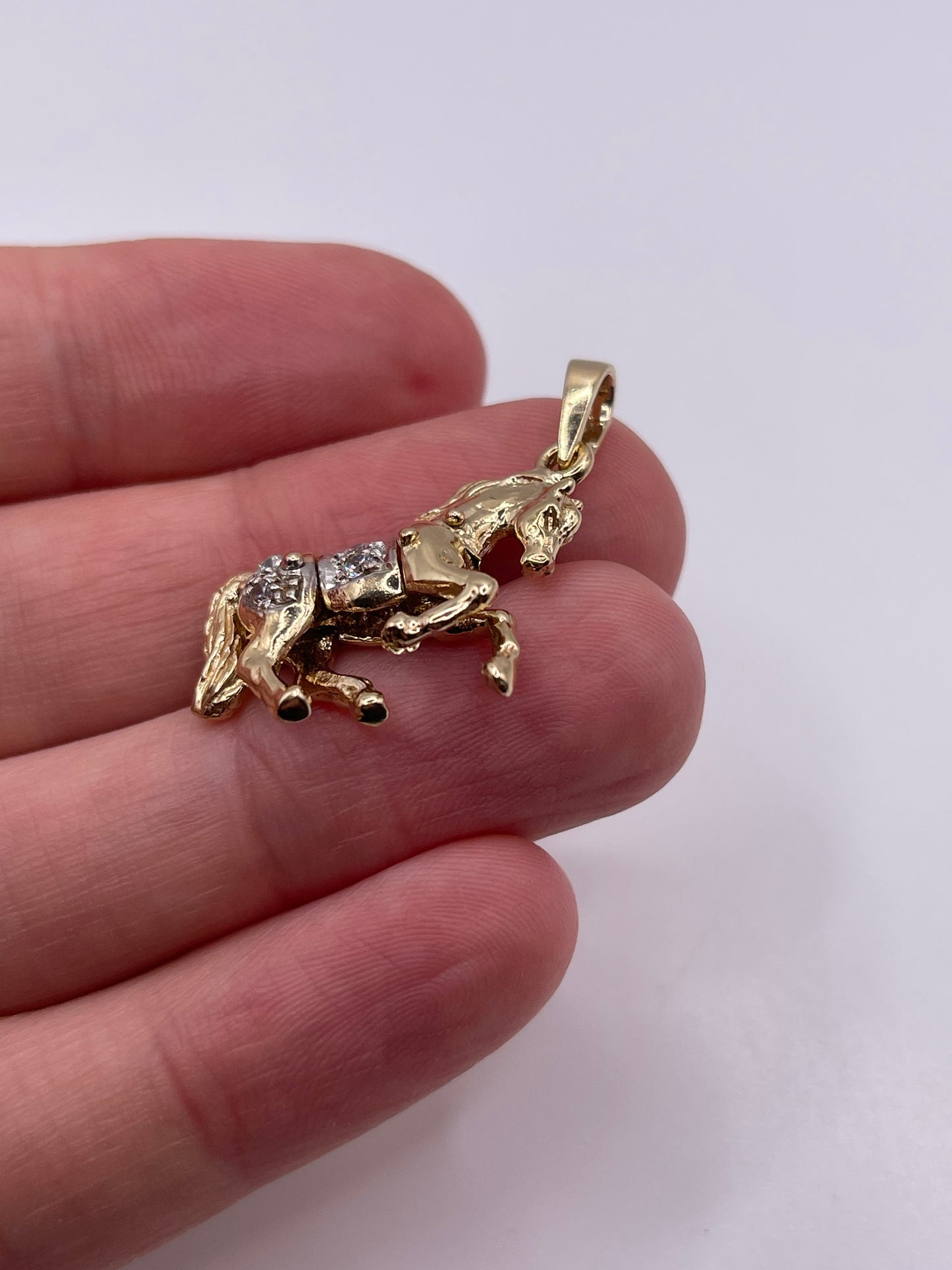 9ct gold stone set articulated horse pendant