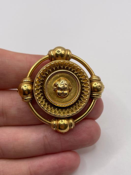 Antique 18ct gold cherub brooch